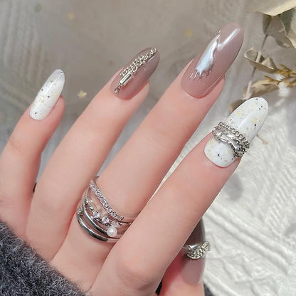 Edgy punk style manicure featuring silver metal chains and caviar beads jewelry accents