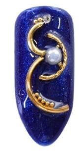 Close up of crescent shaped half moon nail art studs and gold rivets for intricate gel nail decorations.