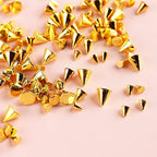 Mini metal rivet studs displayed on artificial nail tips
