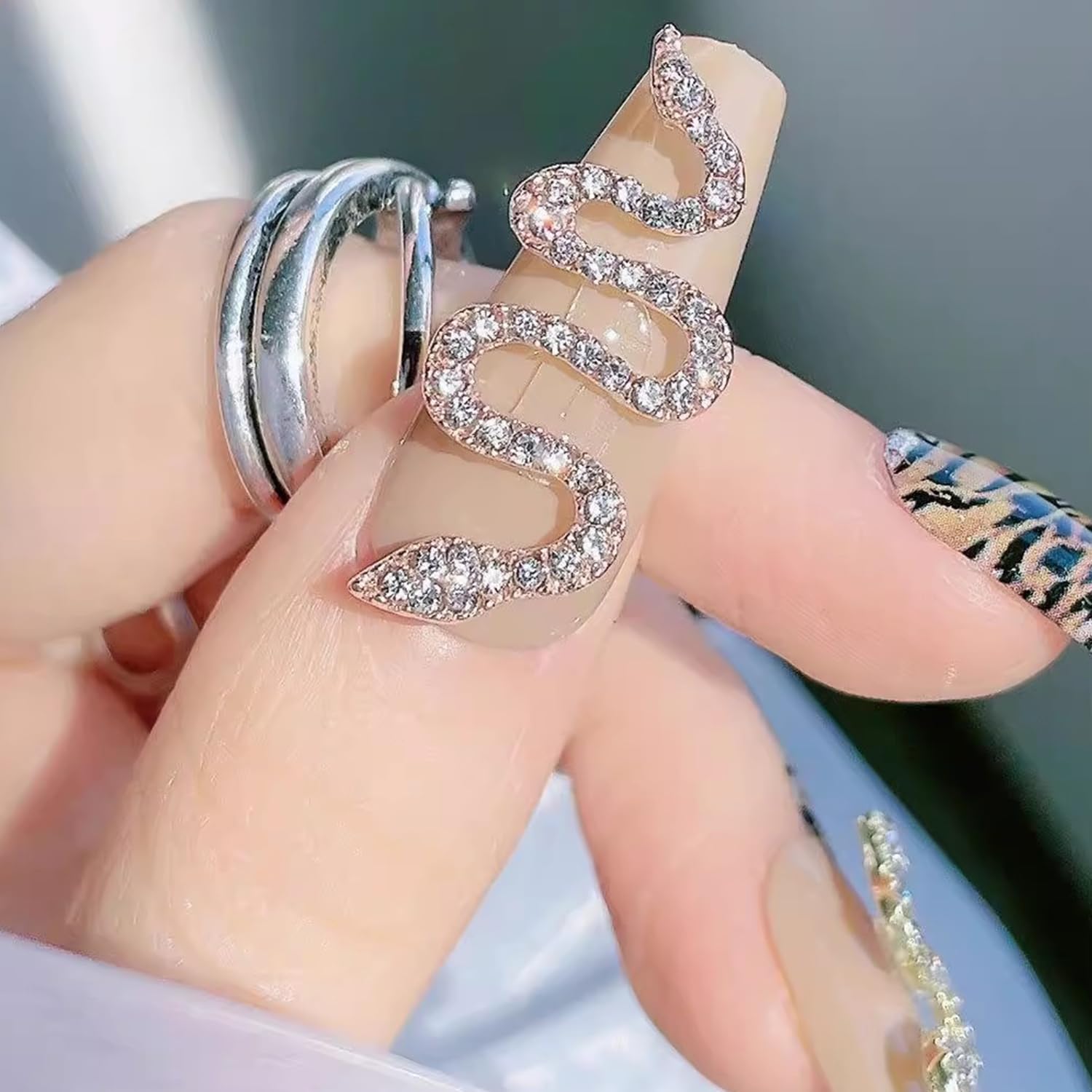 Assorted twenty piece pack of metal snake charms for smartphone case decorating
