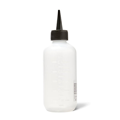 Salon Care applicator bottle being used for hair root treatment
