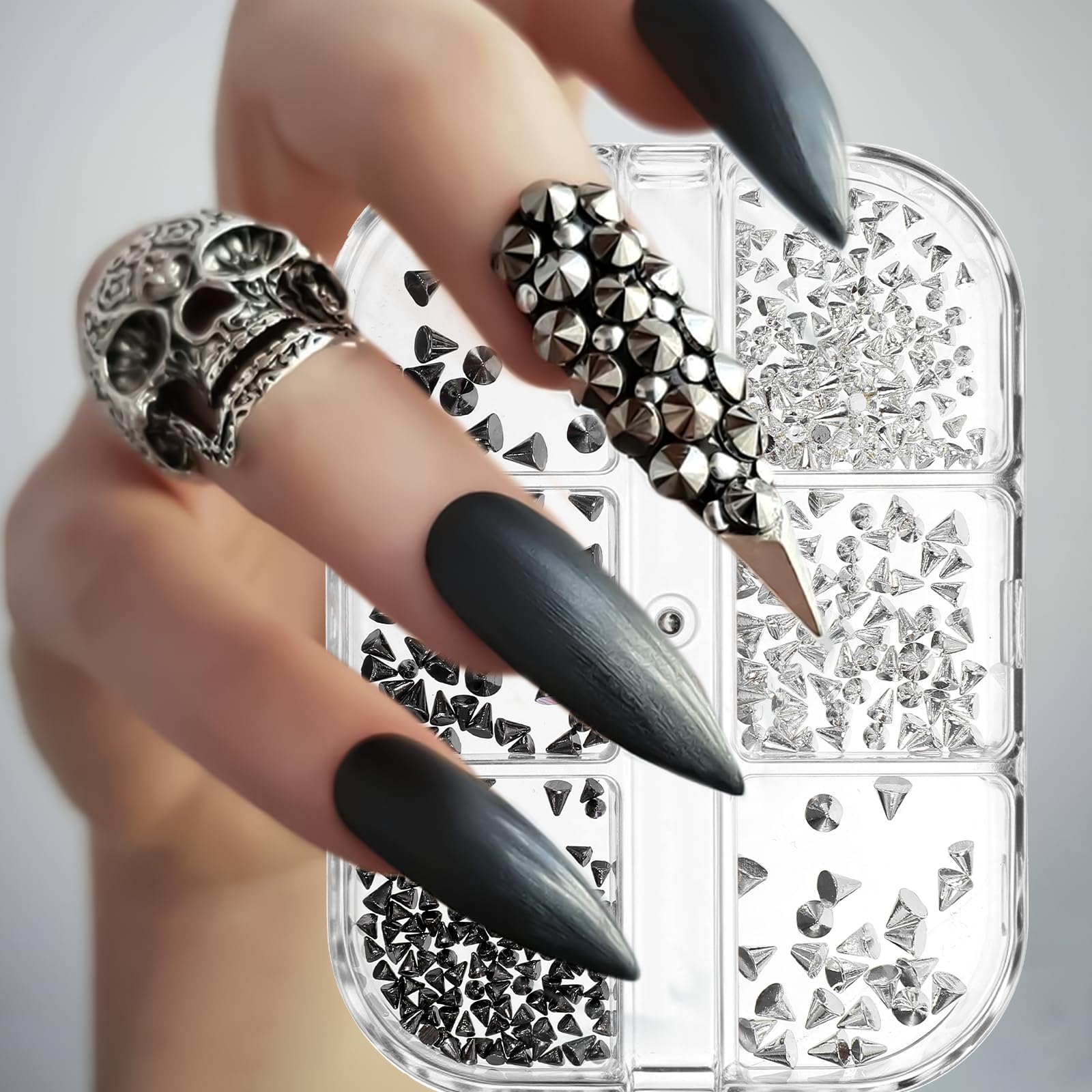 Close up of silver and black cone spikes for nail art