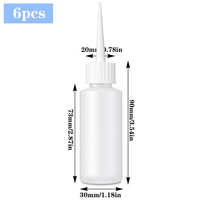 Six pieces of fifty milliliter clear needle tip bottles with protective red caps laid out flat
