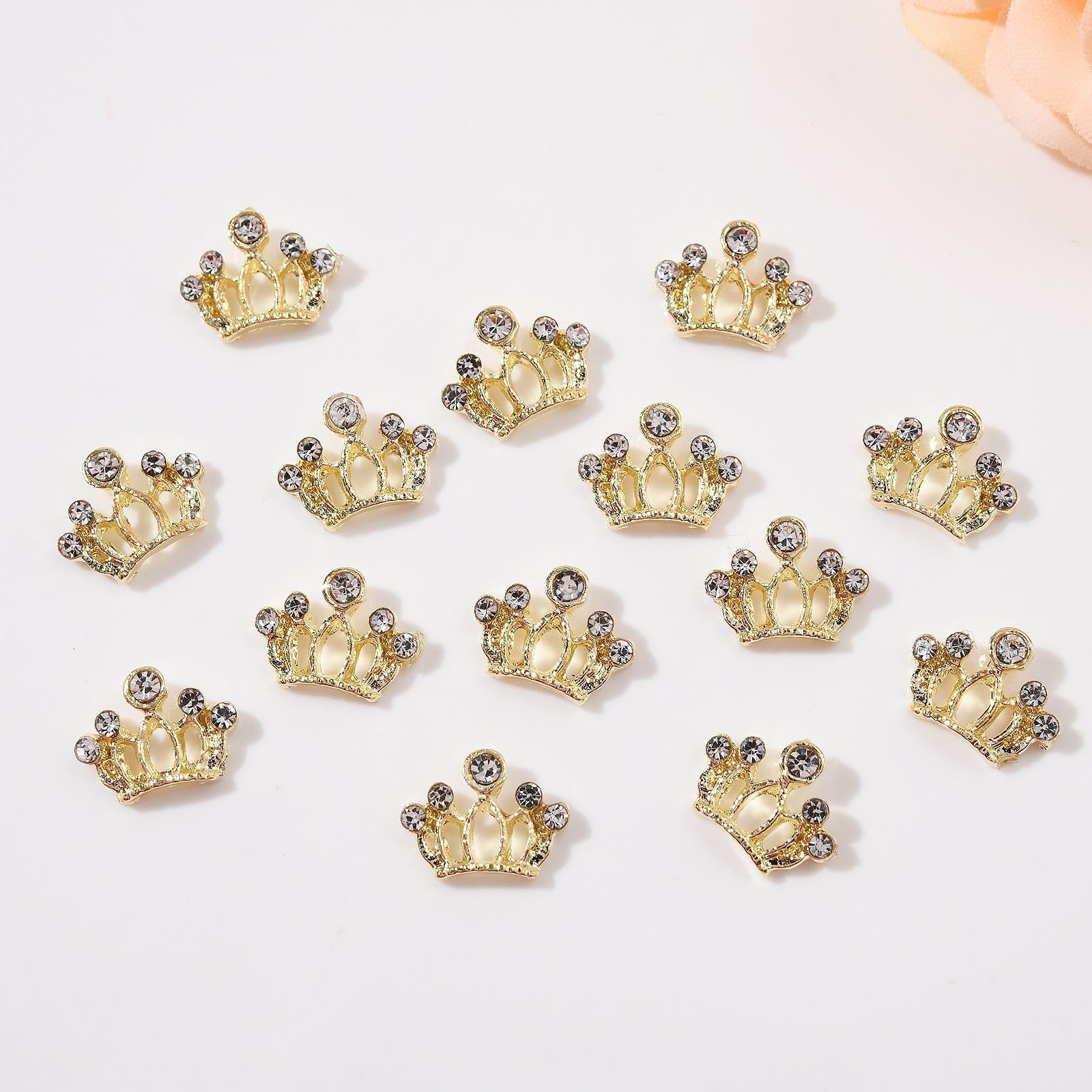 Close up view of gray and silver alloy bow knot nail art decorations on acrylic extensions.