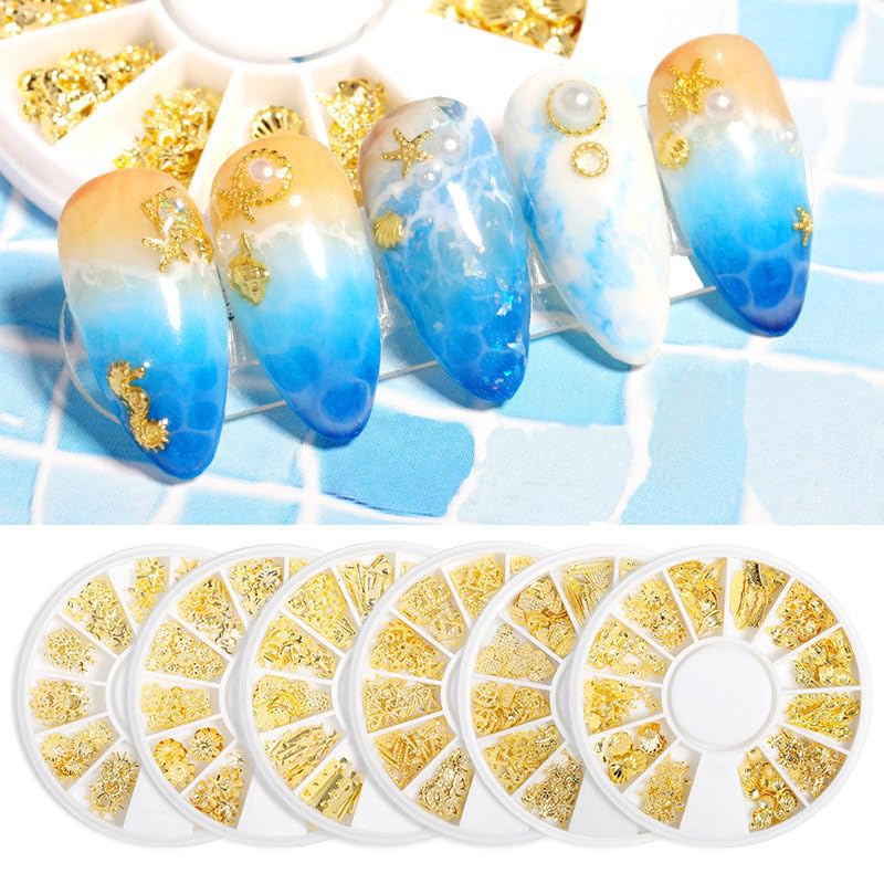 Round twelve grid storage container filled with individual gold starfish and seashell nail decoration pieces.