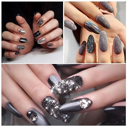 Three dimensional black steel ball gems arranged in intricate geometric patterns on extended acrylic nails.