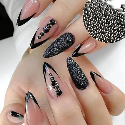 A nail artist using a wax picker tool to precisely place zero point eight millimetre black caviar beads onto a wet top coat.