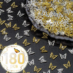 Close up of qiipii metallic alloy butterfly studs and rhinestones for acrylic nails.