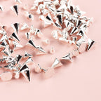 Flatback metal rivet charms demonstrated for DIY craft and manicure use