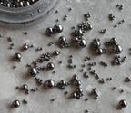 Assorted metallic mini steel ball studs close up