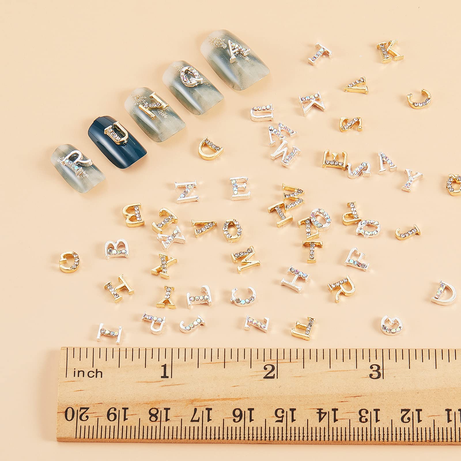 Close up look at the 3D capital letter nail decorations in glittering gold serif font style.