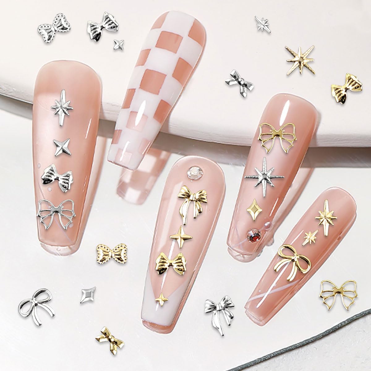 Side view of two compartment boxes containing twelve distinct styles of metallic nail charms for DIY manicures.