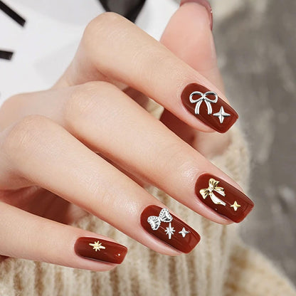 Symphonyw nail art embellishments applied carefully with tweezers onto a fresh gel polish manicure set.