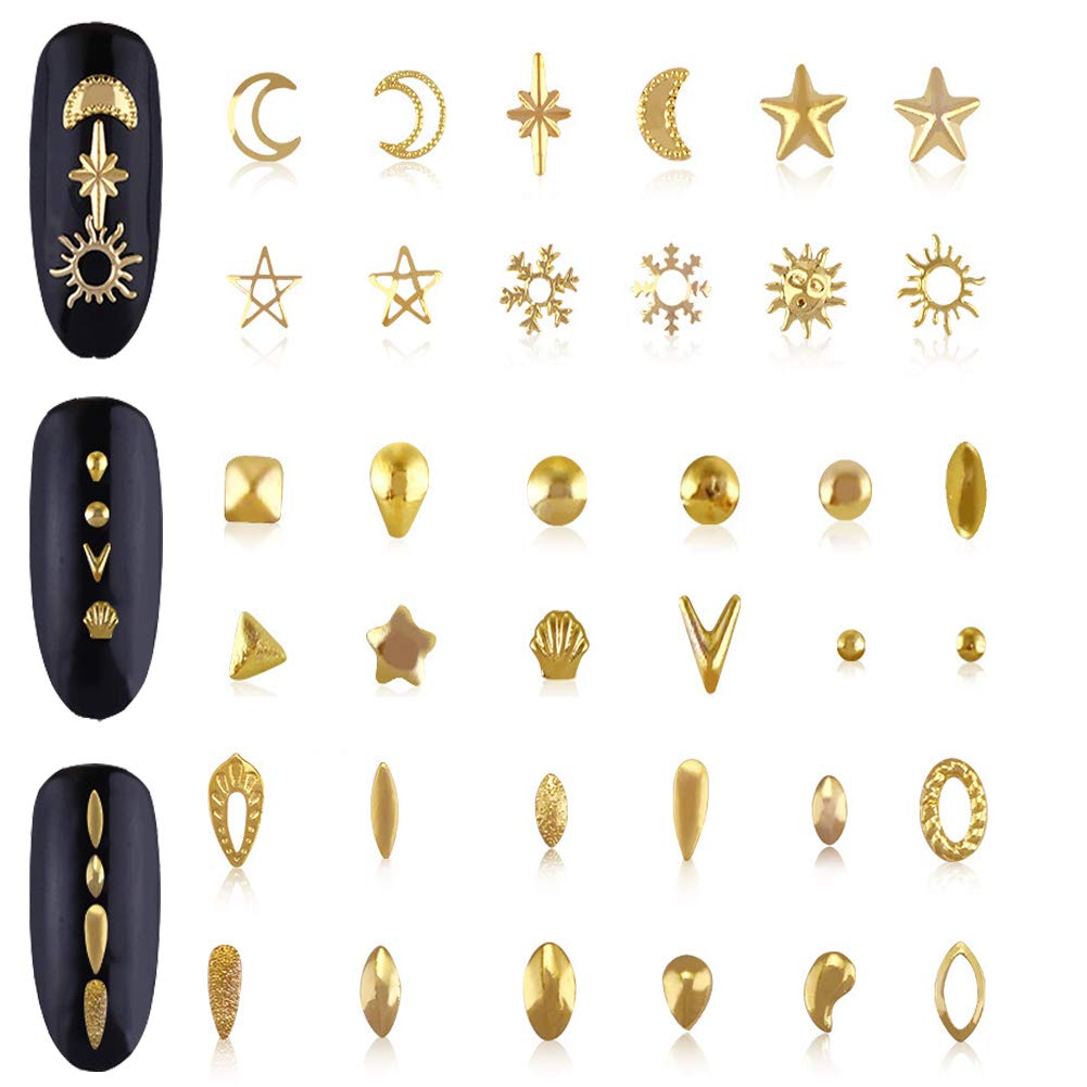 Close-up of gold metal star and moon charms for fingernail decoration