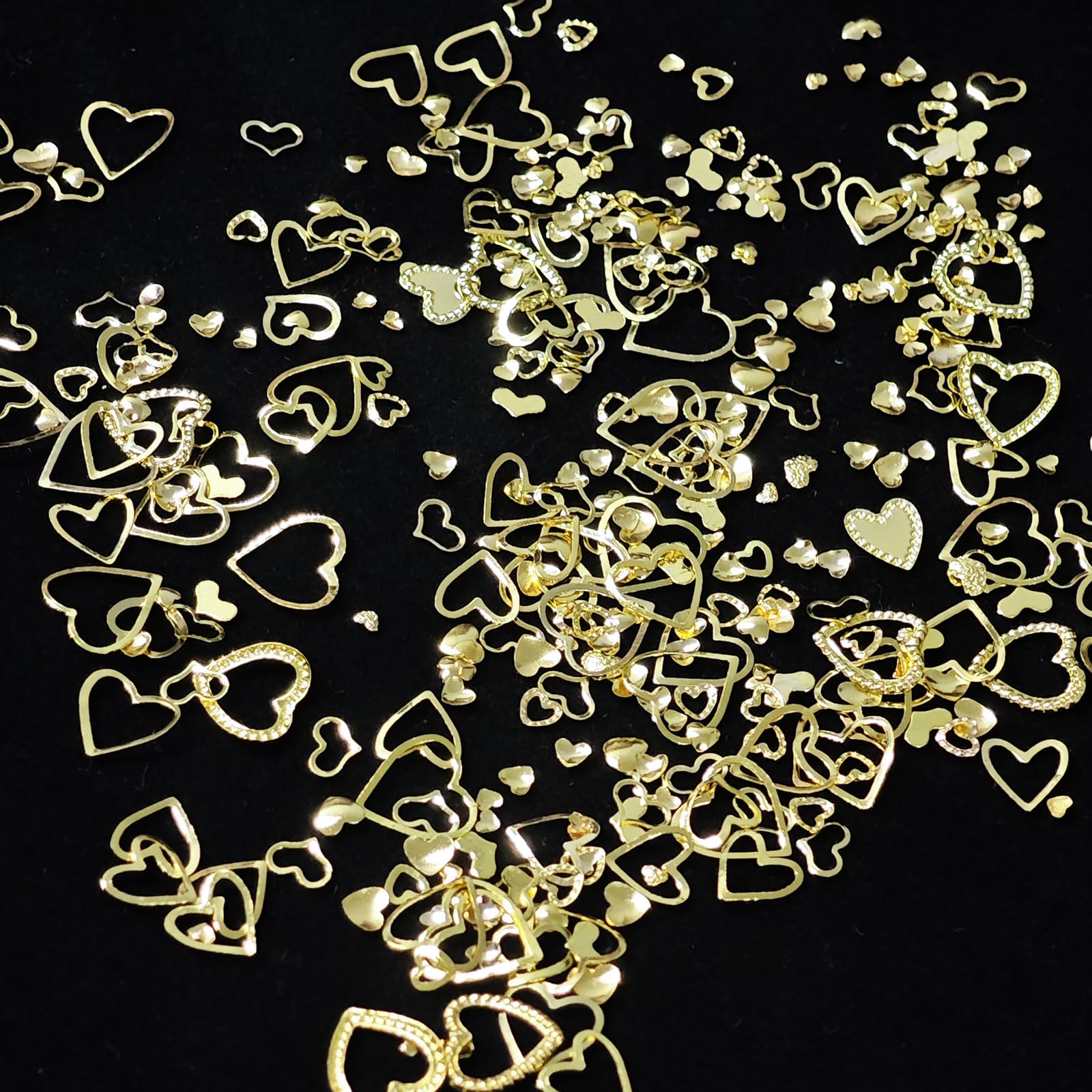 Closer shot of gold 3D rivet embellishments applied on elegant acrylic nails.