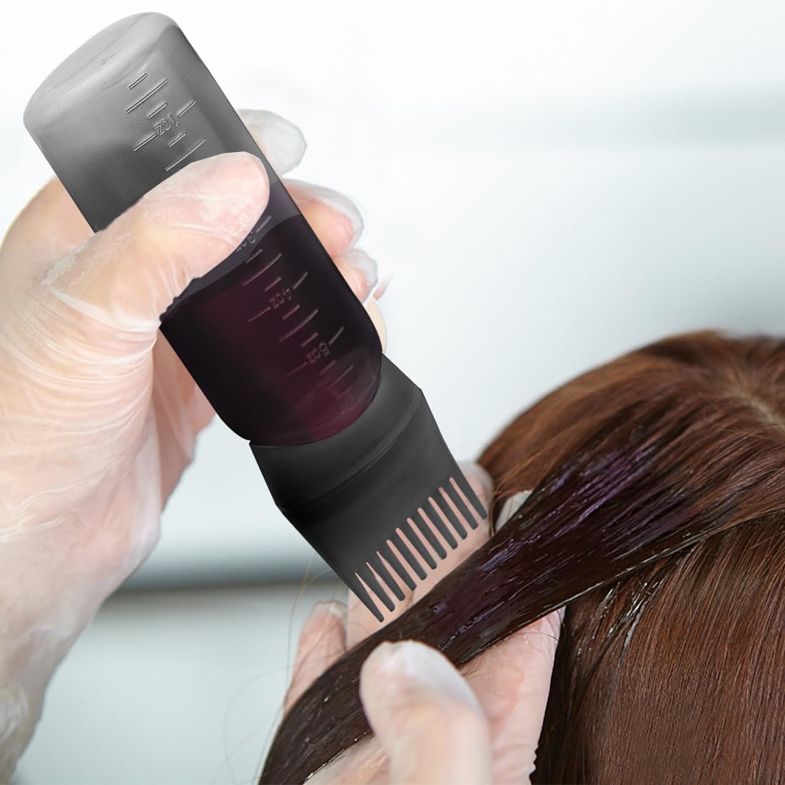 Four pack hair oil applicator bottles in black white pink and purple colors