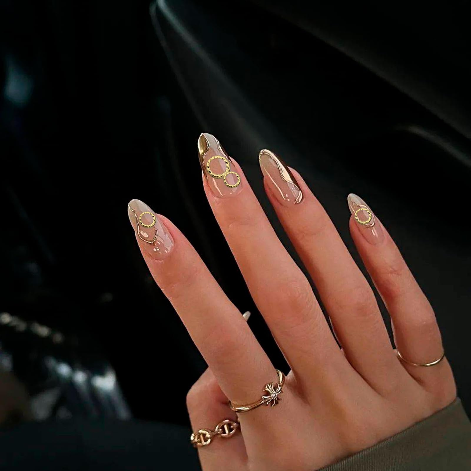 A curated collection of gold circle metal accents beautifully arranged on long acrylic extensions for manicure inspiration.