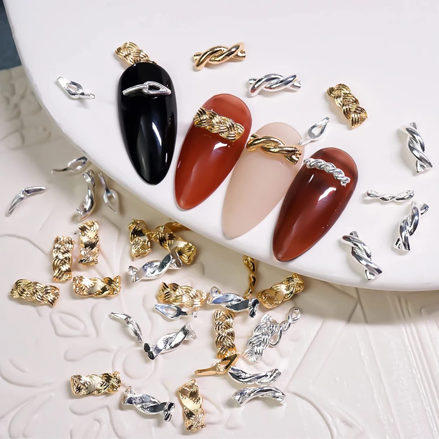 Detailed application process showcasing tweezers positioning a gold chain buckle charm on a cured gel nail extension.