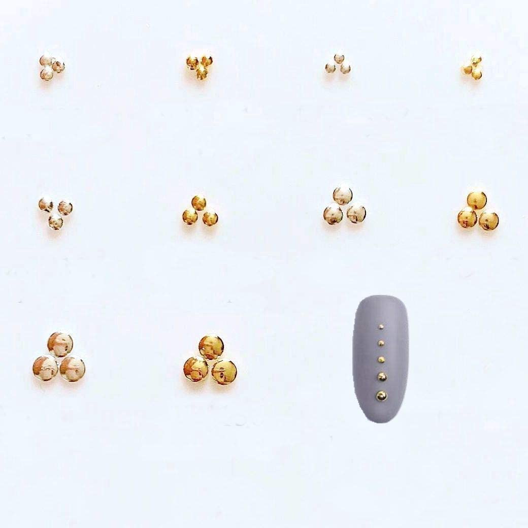 Close up view of silver metallic circular accents used for professional salon style three dimensional nail art.