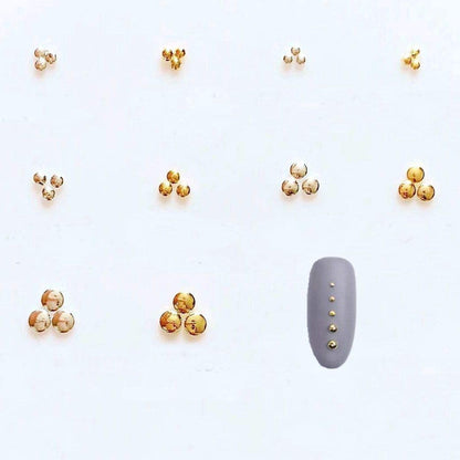 Close up view of silver metallic circular accents used for professional salon style three dimensional nail art.