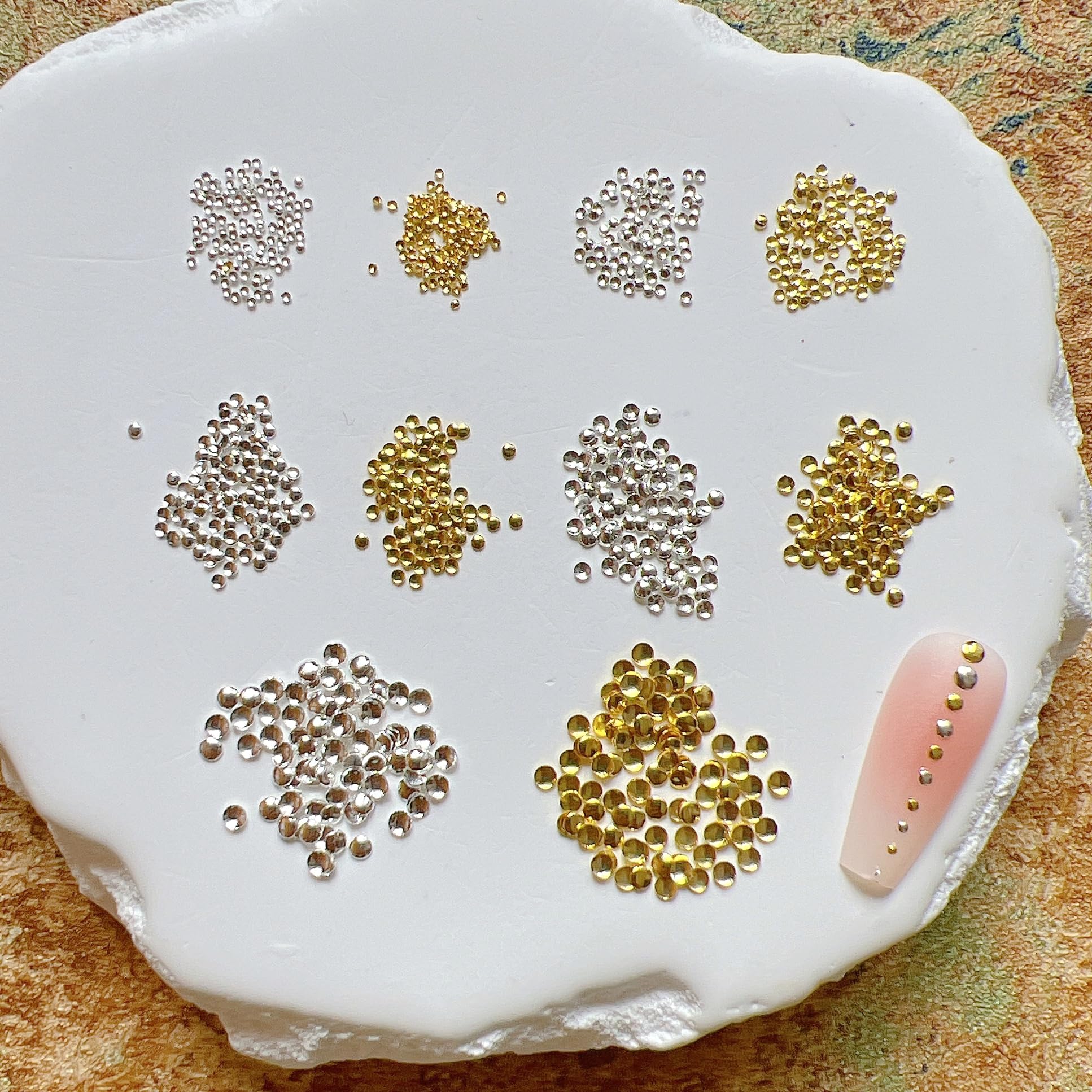 Detailed scale view comparing the five different millimeter sizes from ultra small to large round studs.