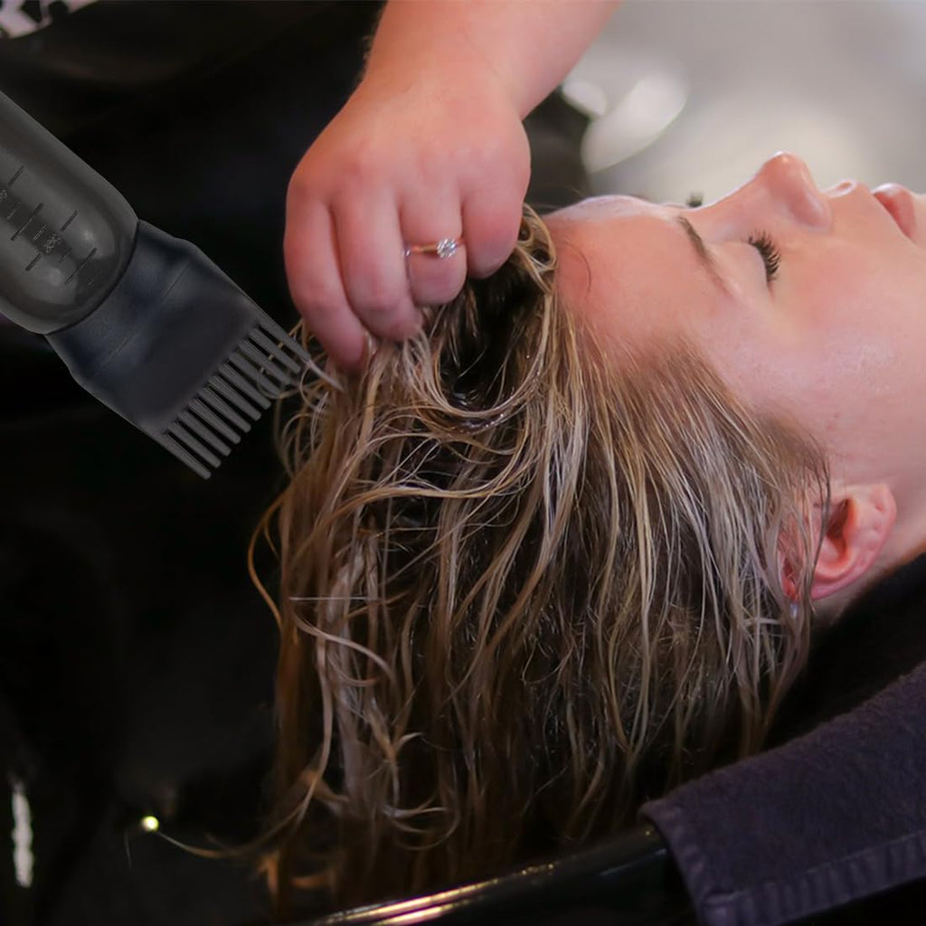FZWONVUC scalp oil applicator bottle being squeezed to demonstrate clean and controlled liquid flow through the integrated comb head