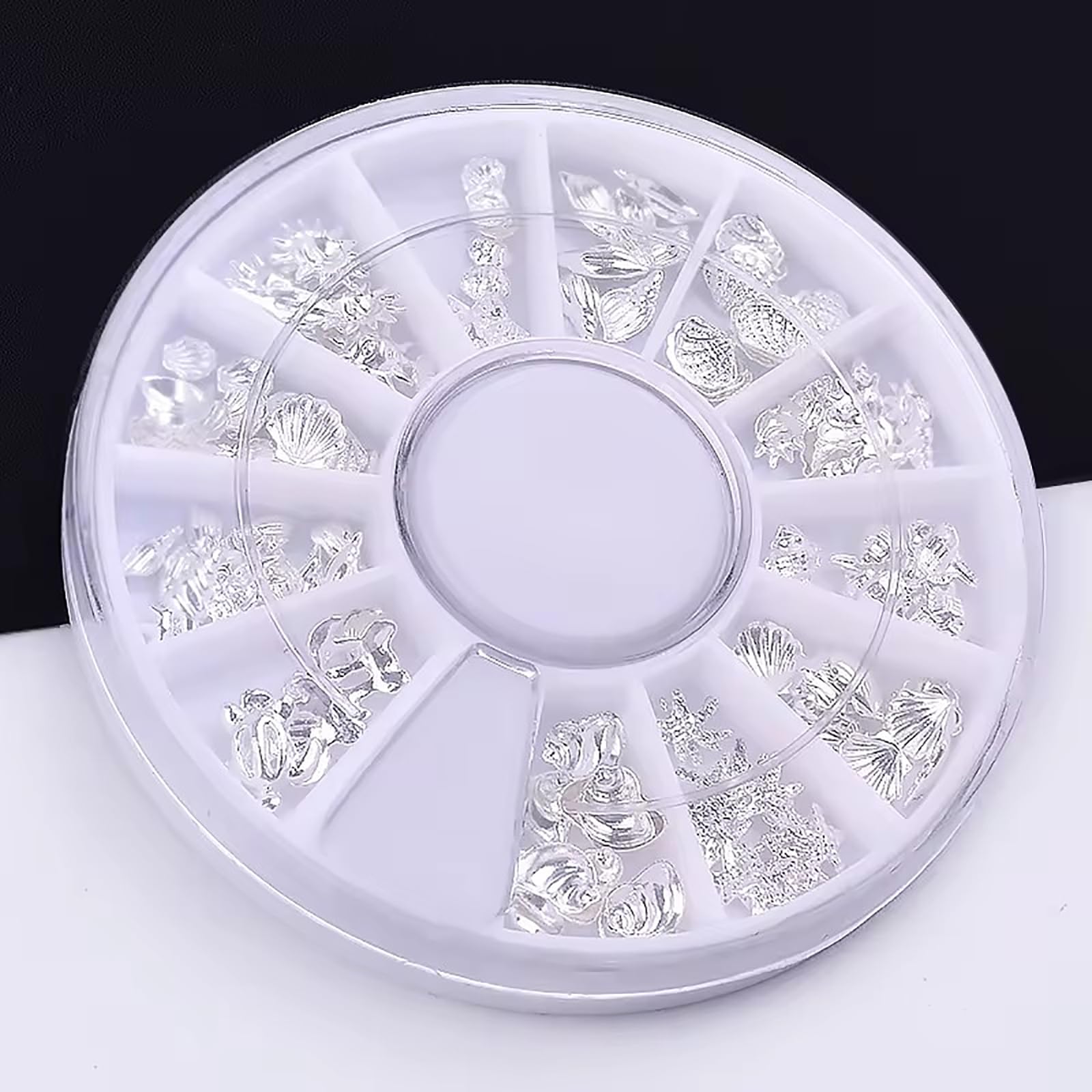 Durable stainless steel alloy ocean series nail studs displayed on a flat surface for DIY manicure sizing.