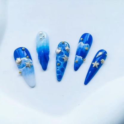 Two boxes of ONEUPIN beach theme nail rhinestones and silver alloy rivets for salon quality styling.