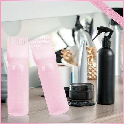 Two pack bundle of the pink BLAAROOM hair coloring and oiling applicator tools resting on a clean surface.