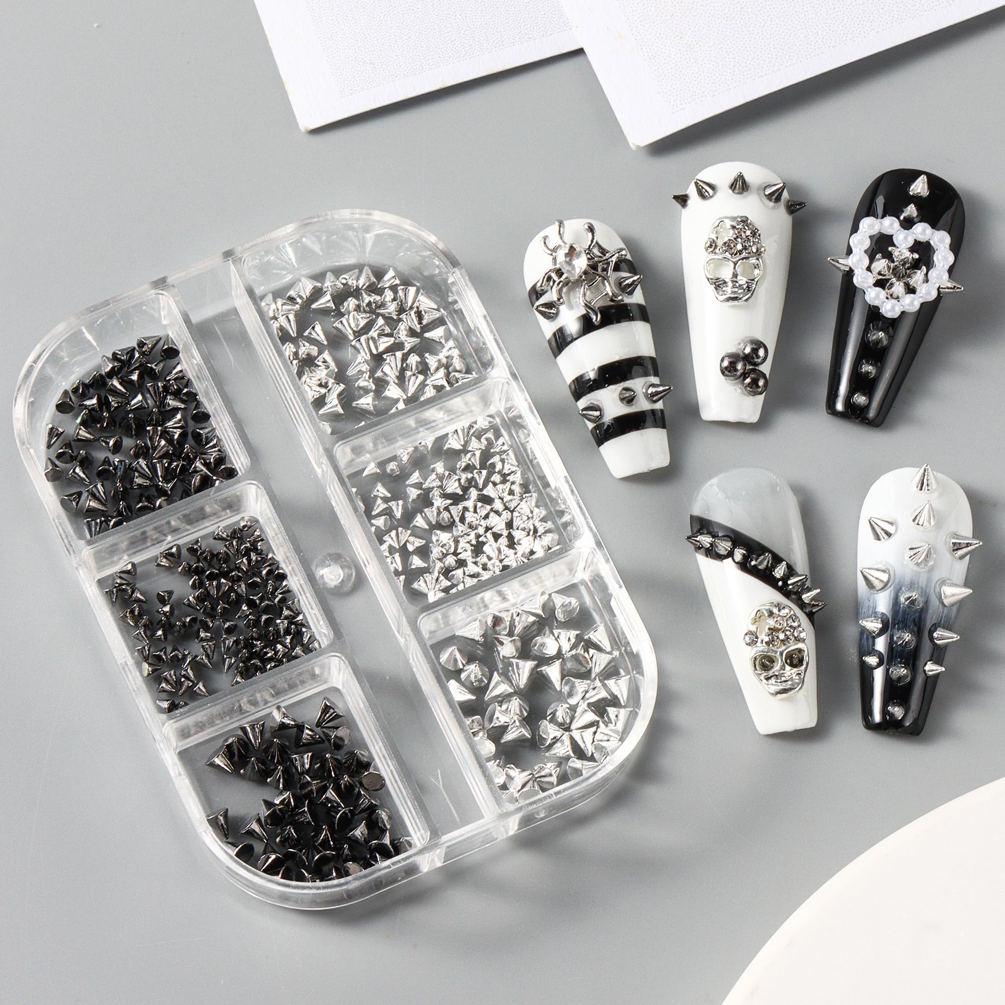 Edgy gothic manicure design example featuring the 3D metal punk spikes and steel beads on acrylic extensions