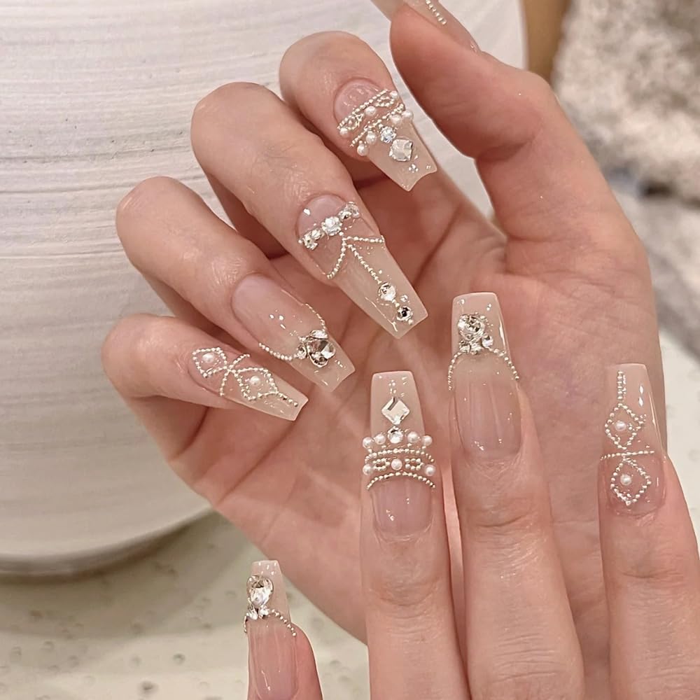 Intricate spider and web manicure design created using gold and silver mini metal rivets.