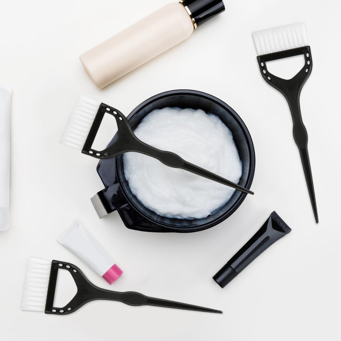 Close up of professional hair color brushes with ergonomic handles.