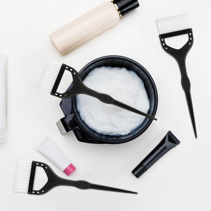 Close up of professional hair color brushes with ergonomic handles.