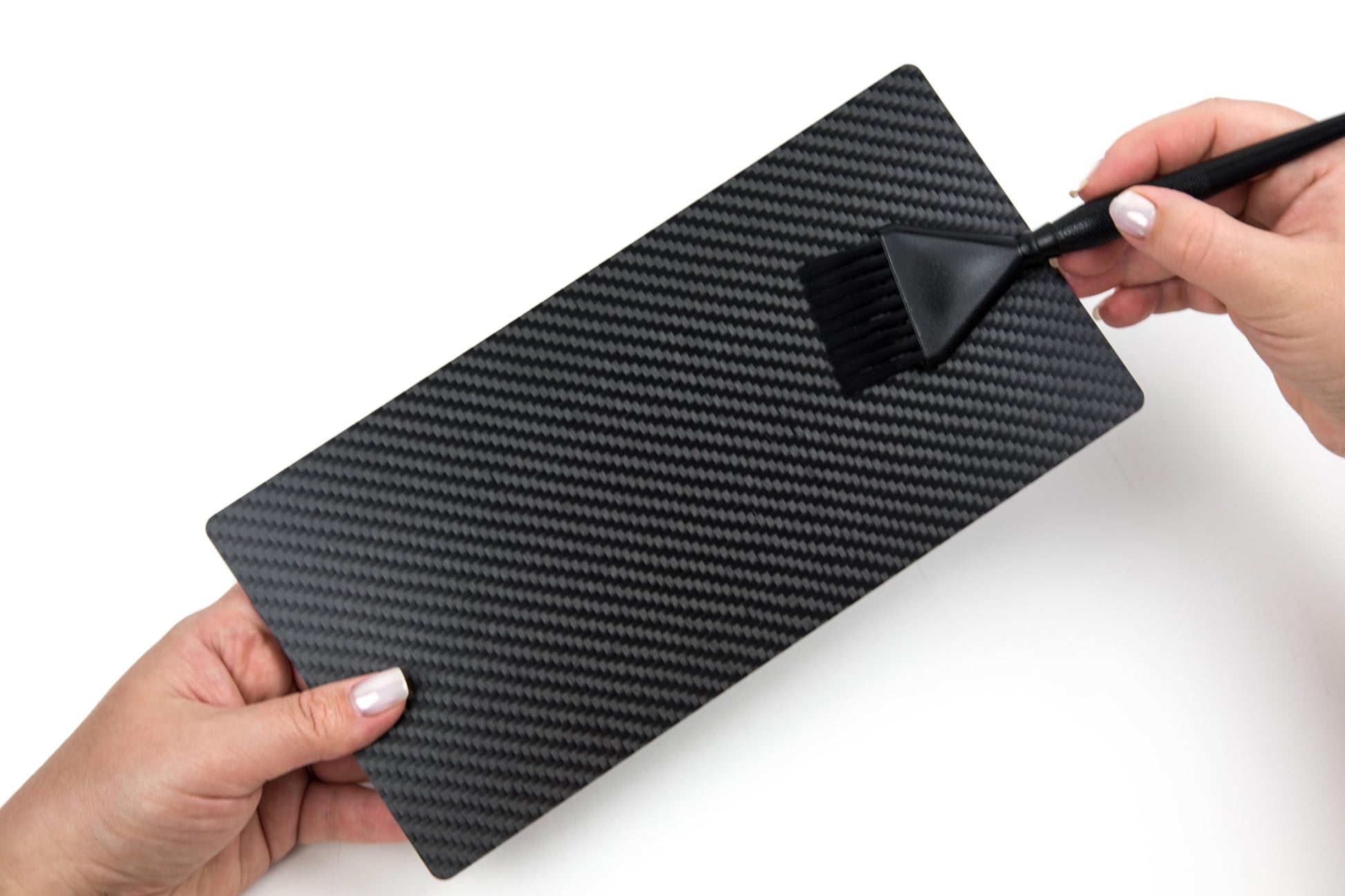 Lightweight black carbon fiber hair board held in hand