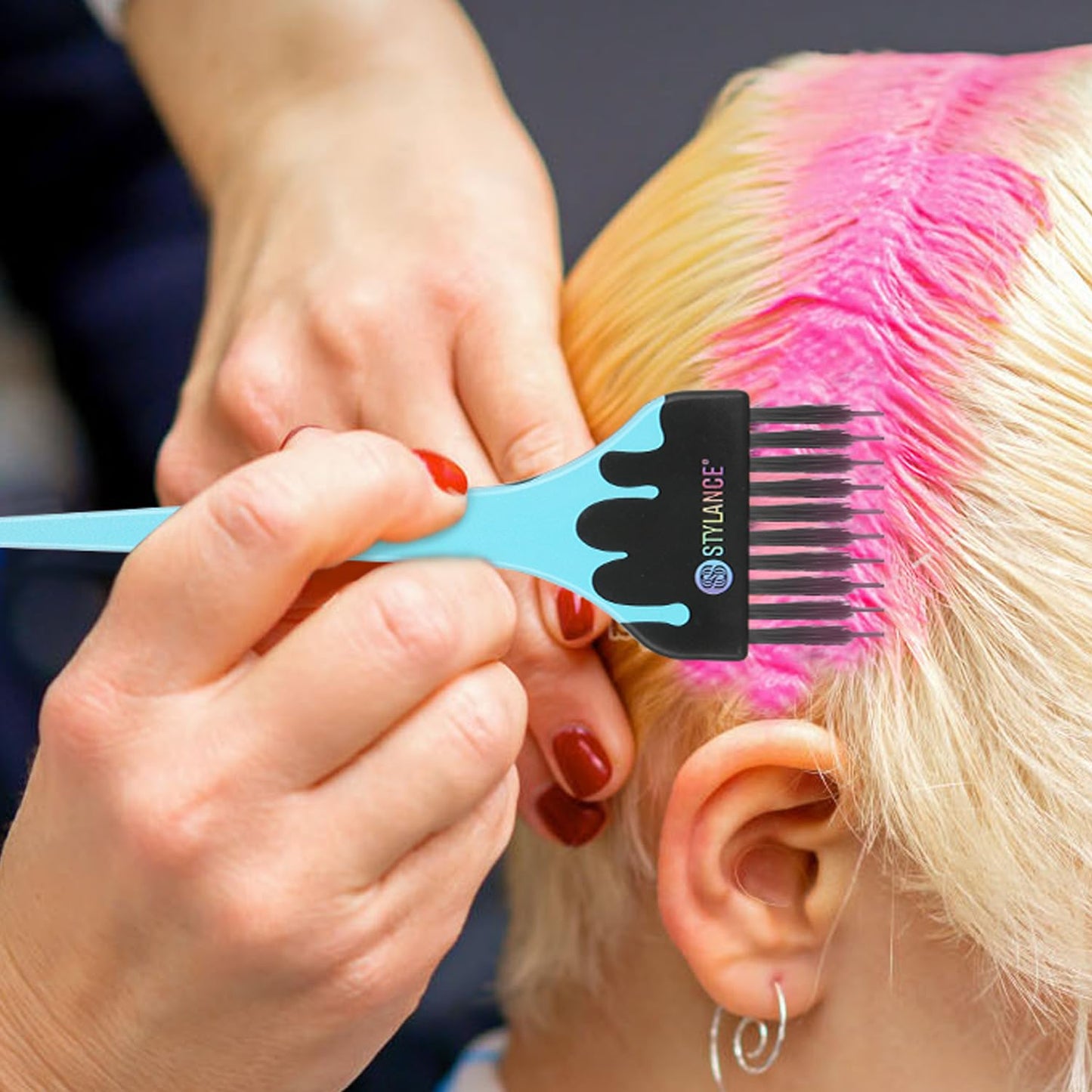Professional hair stylist using color brush for balayage