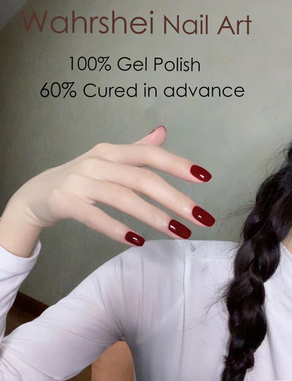 Hands displaying salon quality manicure with wine red nail strips