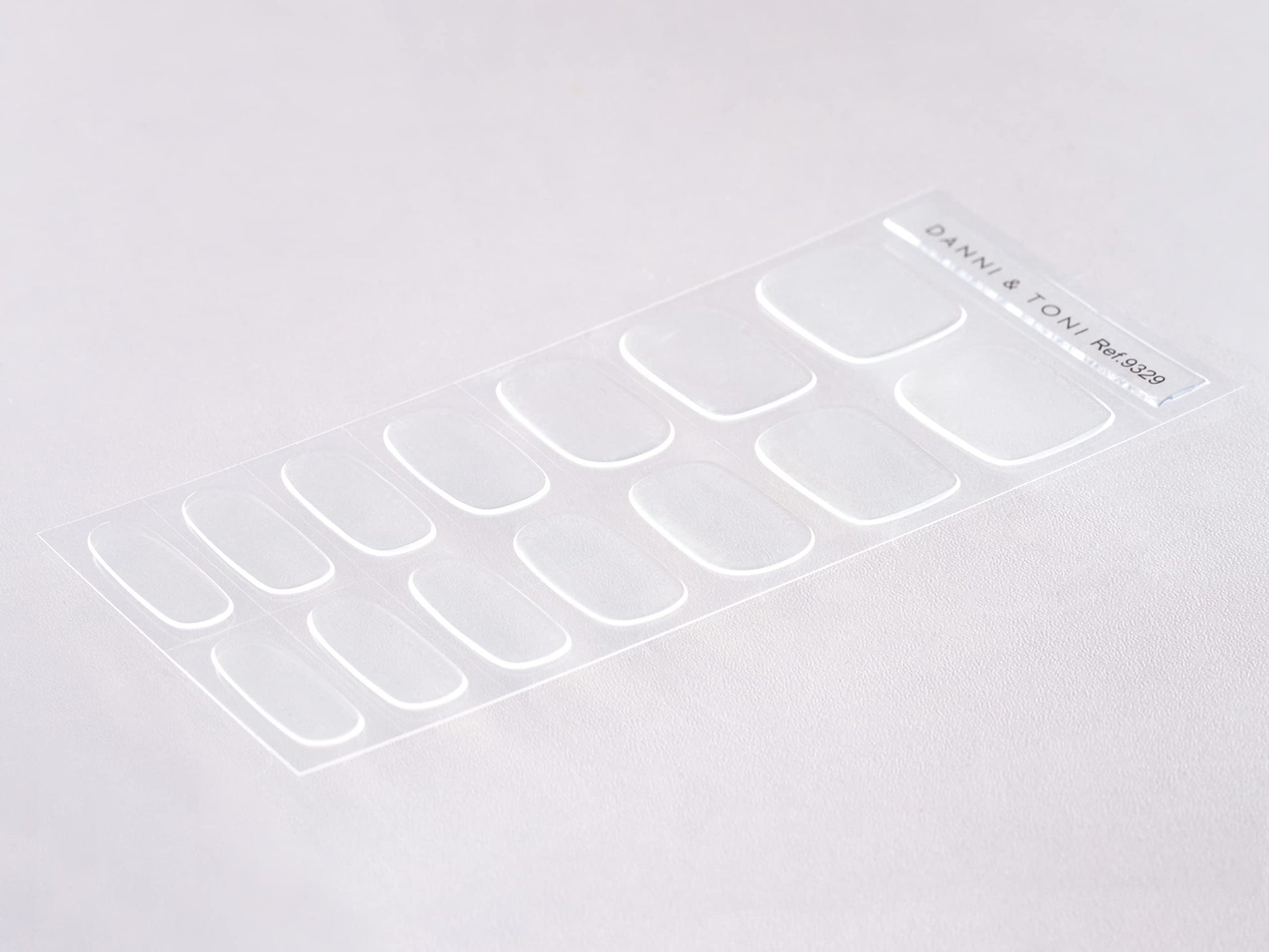 Close up of crystal clear gel nail strips on fingernails