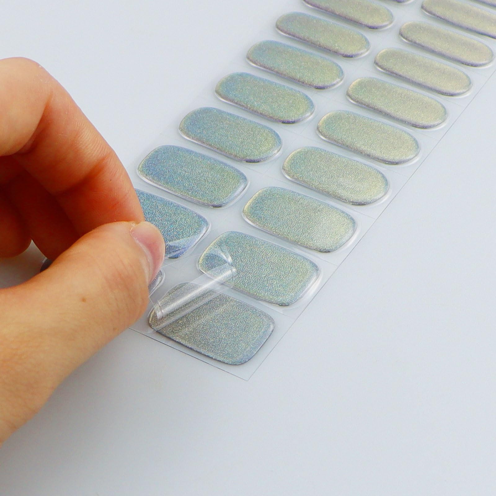 Hands displaying salon-quality blue purple glitter gel nail art