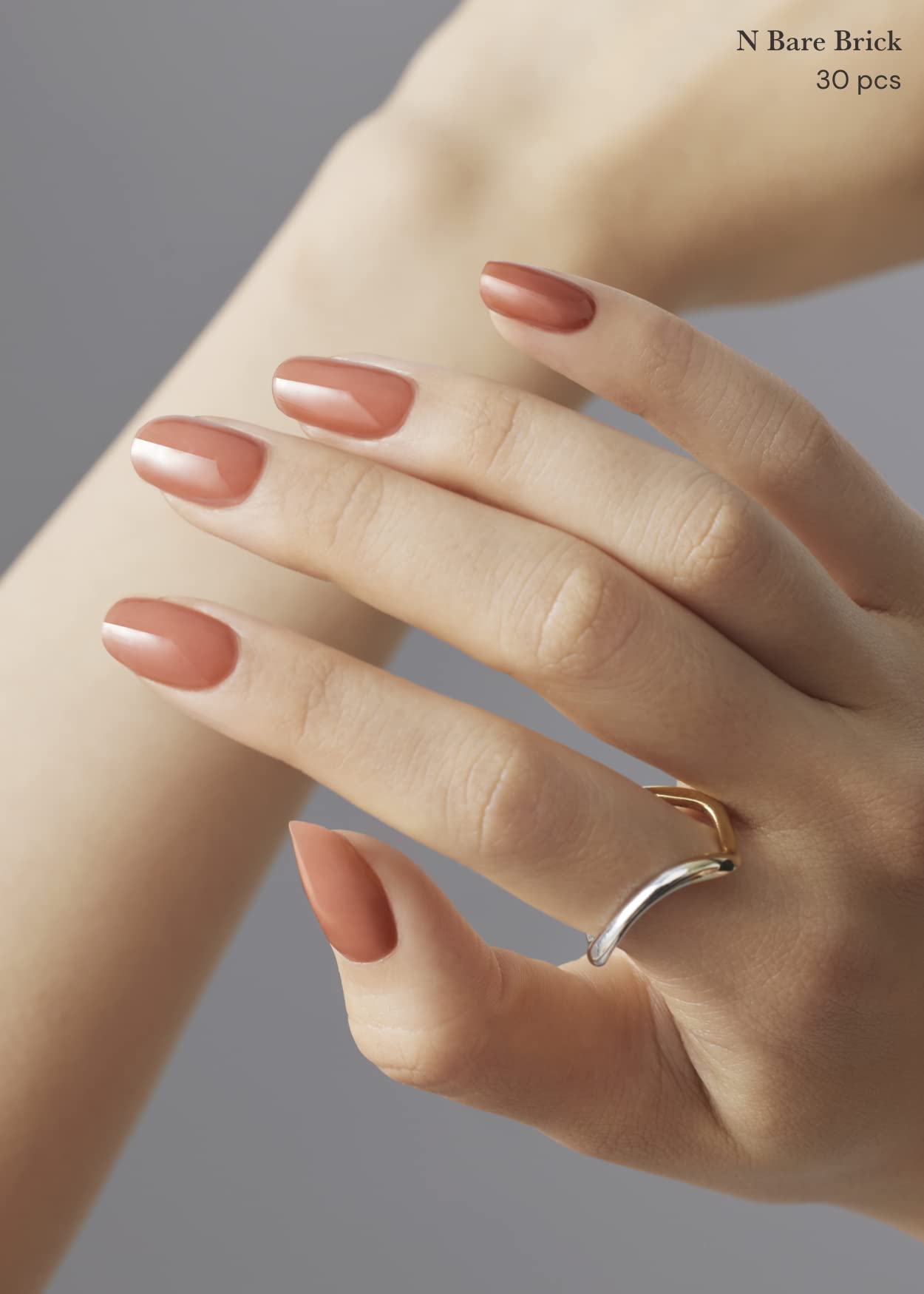 Hands displaying Ohora N Bare Brick salon quality gel nail art