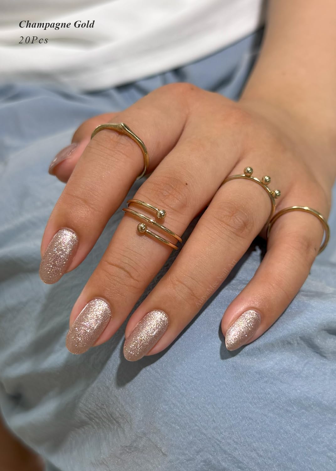 Close up of sparkling Champagne Gold gel nail wraps on hand