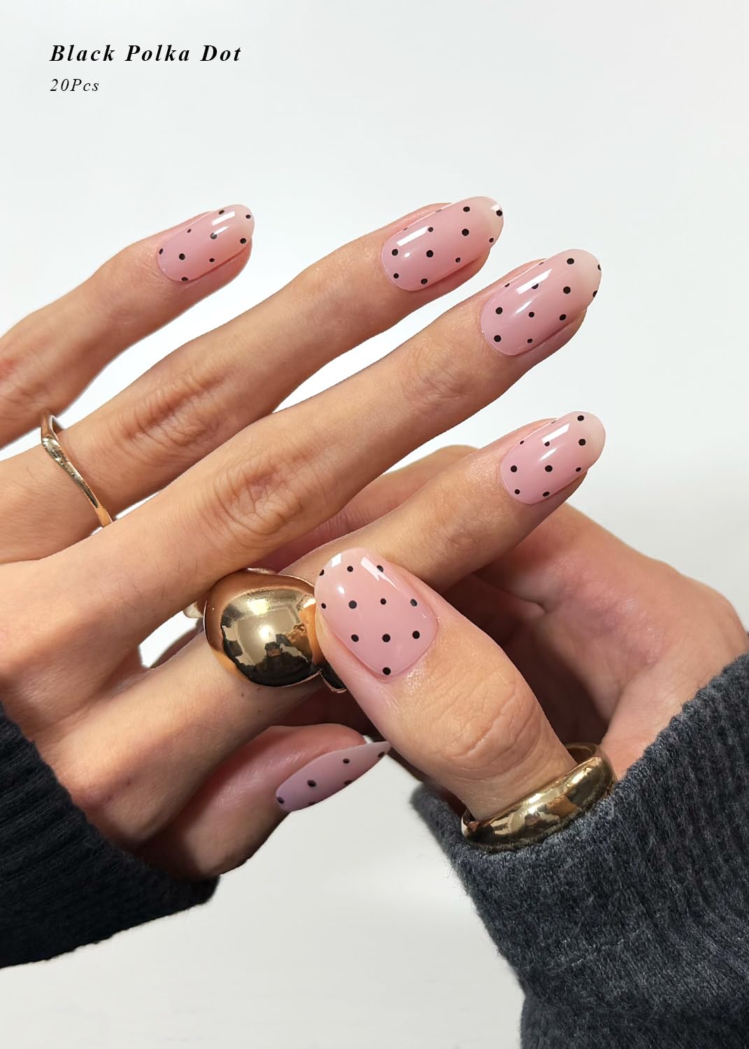Close up of black polka dot gel nail wraps on fingernails
