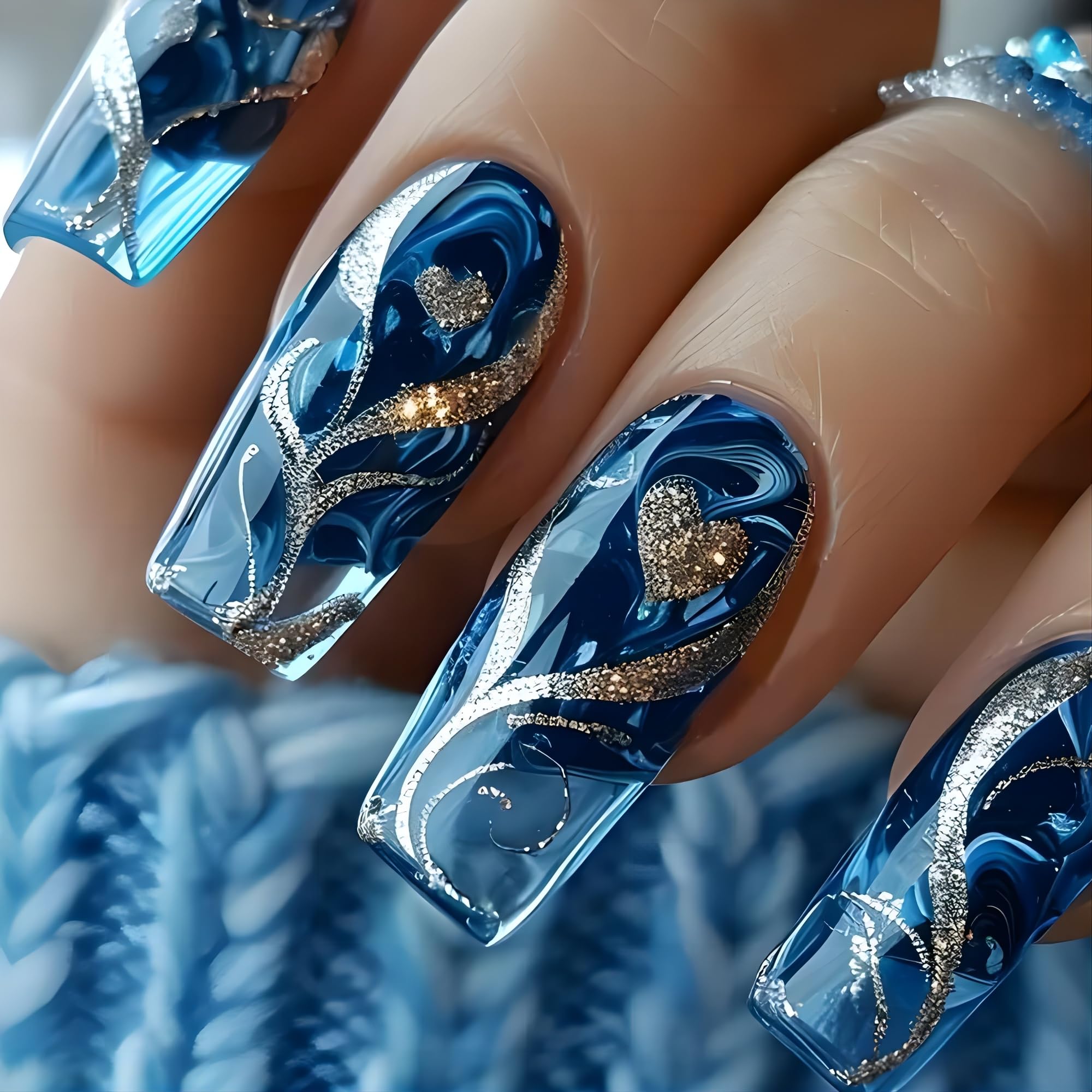 Close up of blue gel nail wraps with gold heart detail