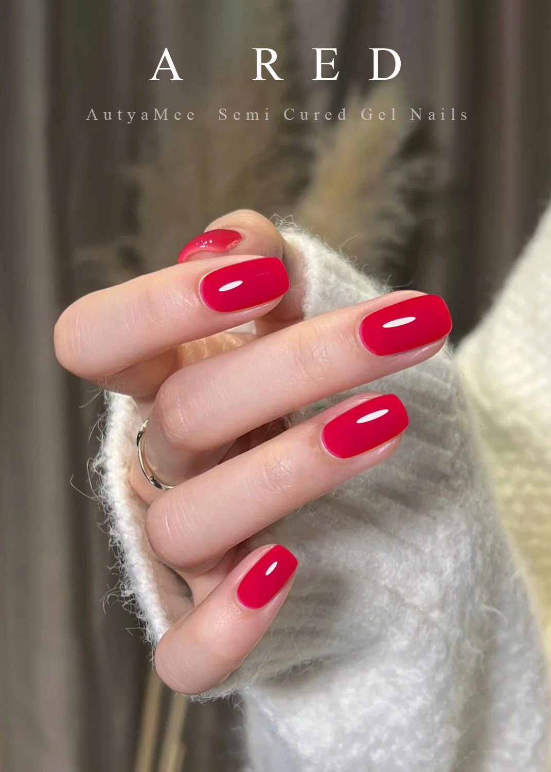 Close up of glossy red gel nail strips on fingernails