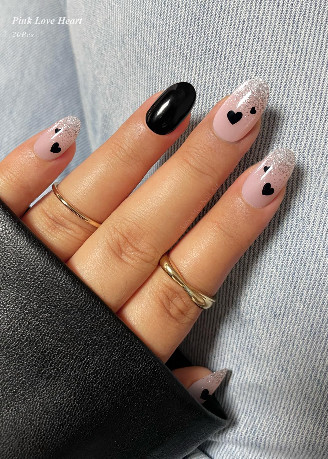 Close up of nude base gel nail strips with black hearts