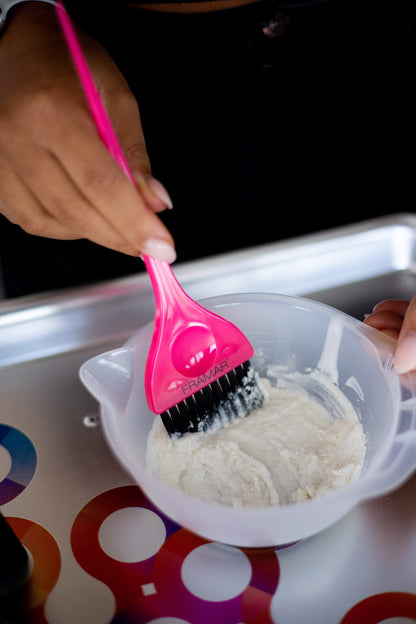 Professional stylist using Framar pink color applicator brush