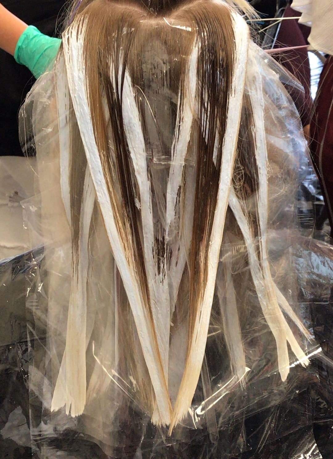 Professional using Framar film for hair color application