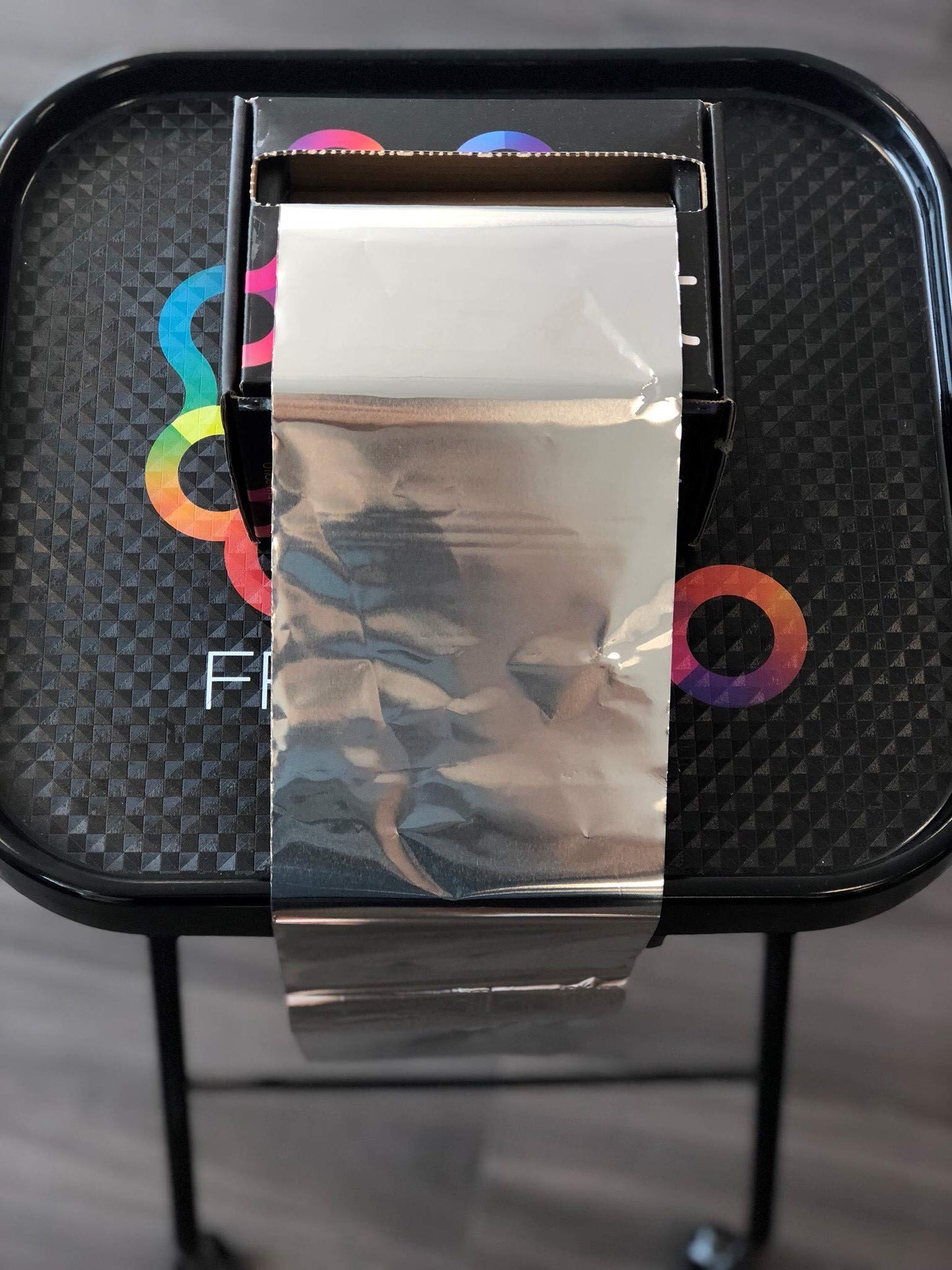 Professional hair stylist using Framar foil for highlights