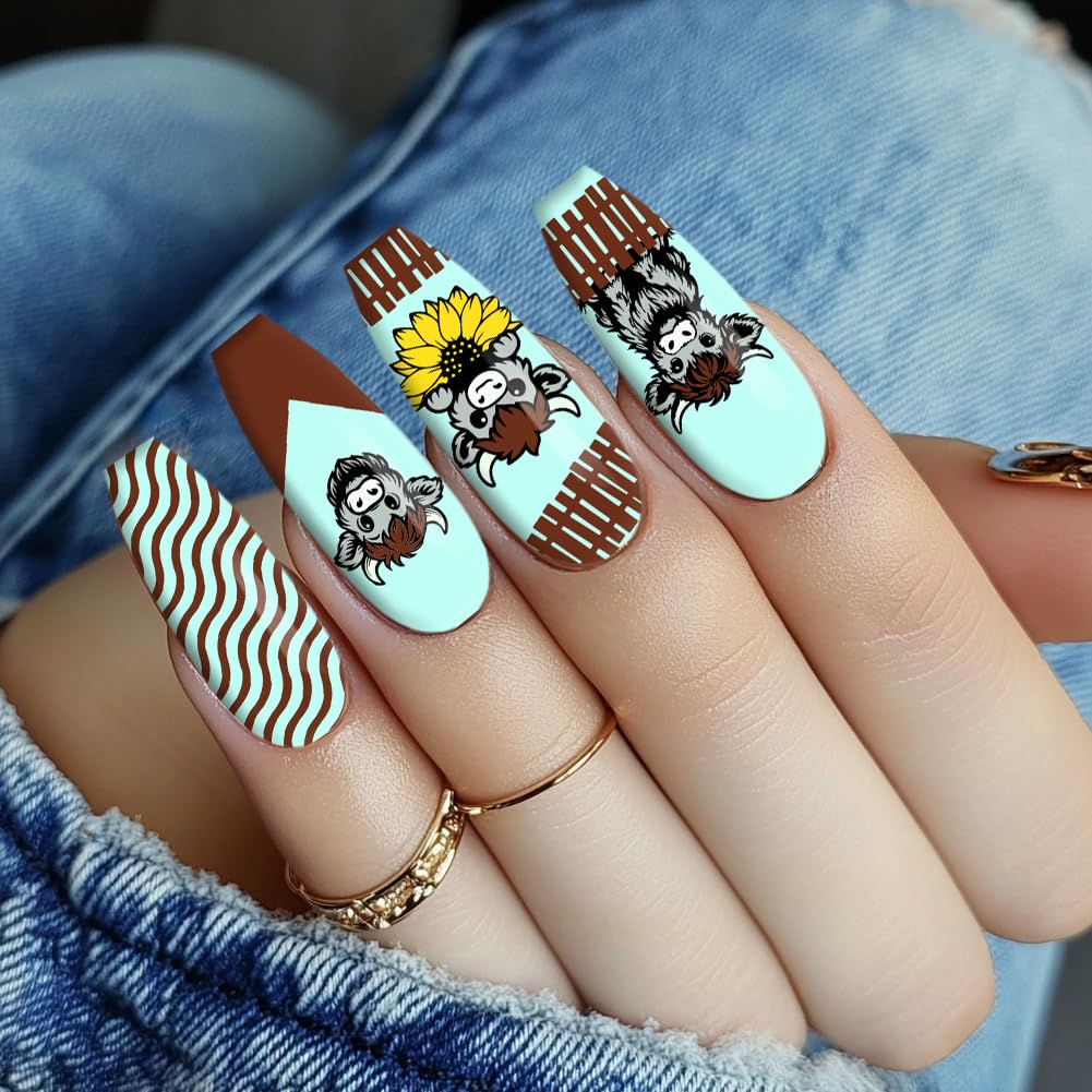 Completed manicure art sample featuring playful highland cattle transfers and floral borders on long square nails.