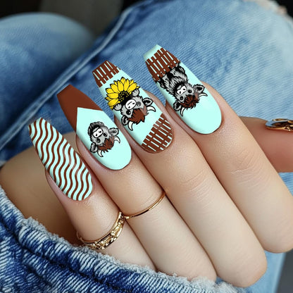 Completed manicure art sample featuring playful highland cattle transfers and floral borders on long square nails.