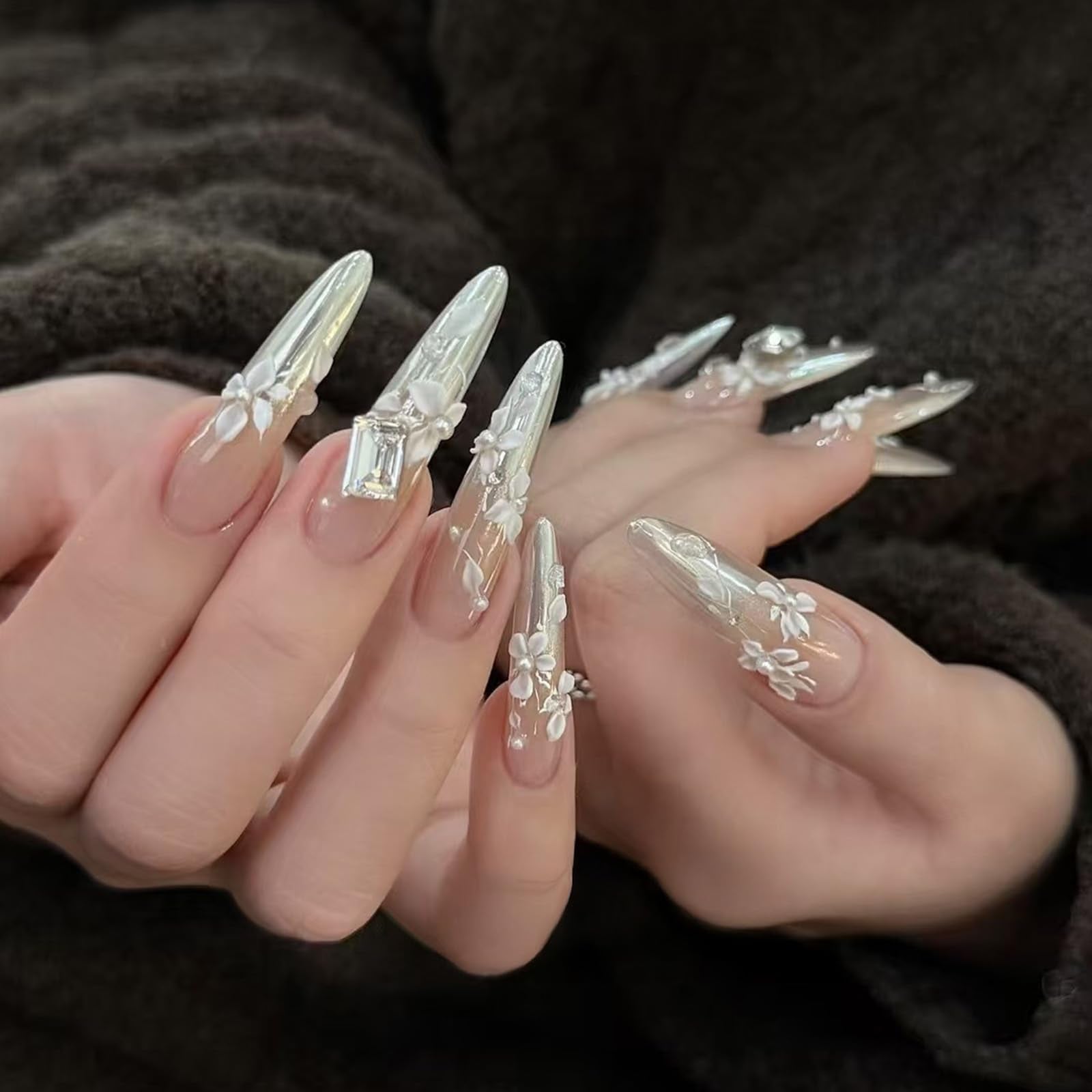 Completed spring manicure design featuring raised white floral charms created with the silicone stencil.